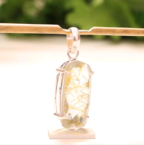 Silver, golden rutile pendant